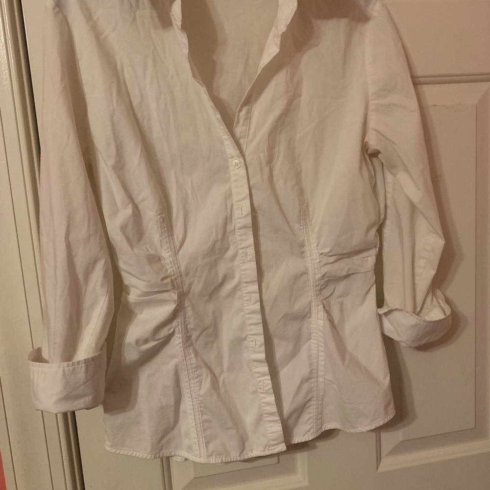 Fitted, white button down blouse thats stretchable